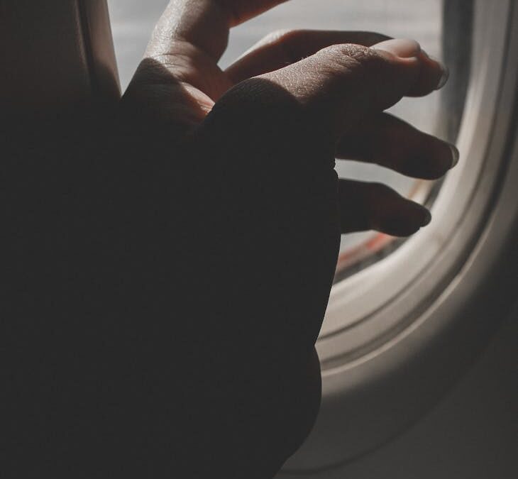 hand by airplane window